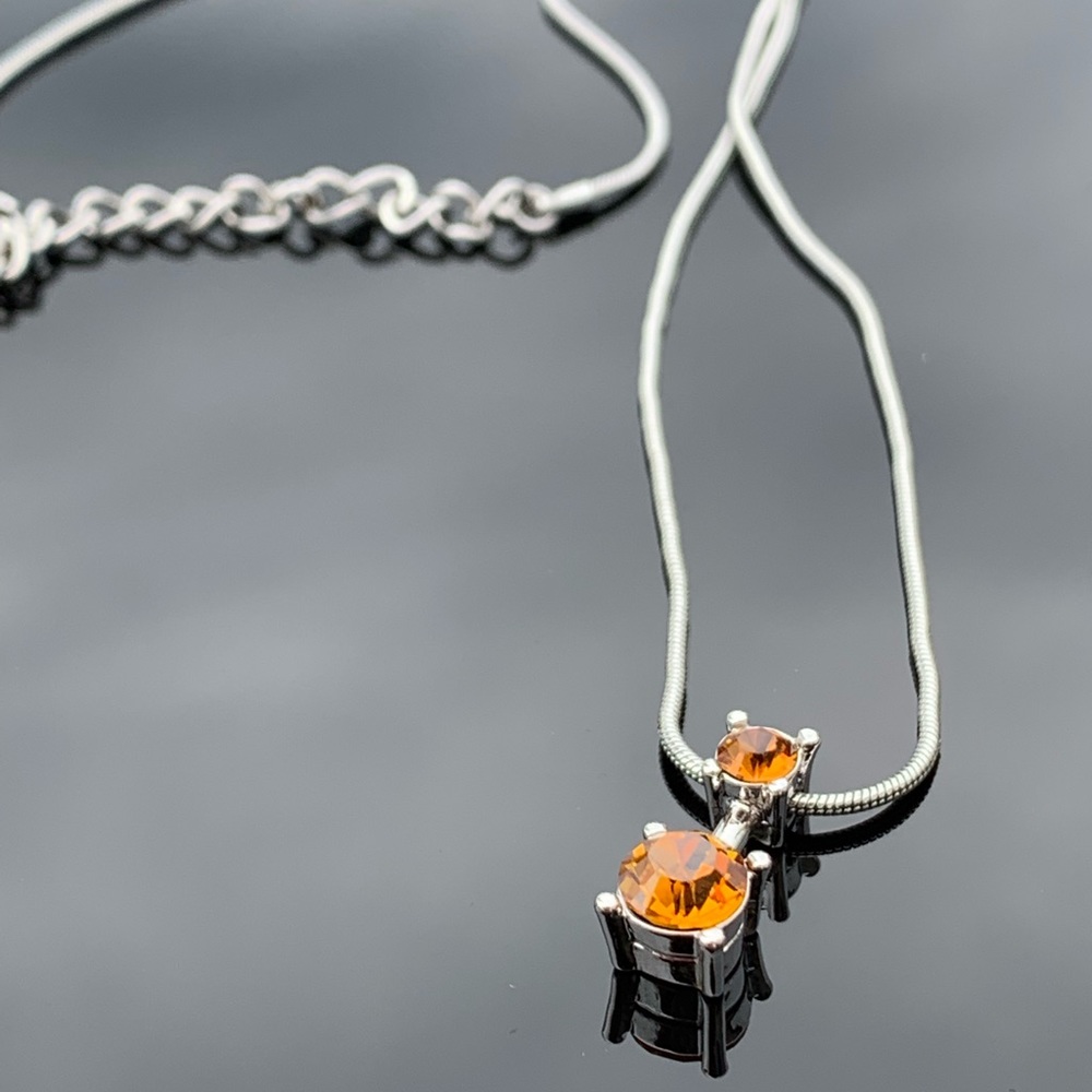 Orange crystal pendant necklace.